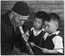 Chinese caretaker at Joss House with Ng children