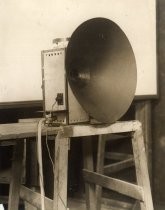 Speaker, on wooden bench, possibly laboratory