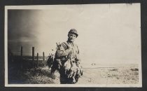 Unidentified man with game birds