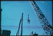 Worker on crane during demolition of building near St. Joseph's