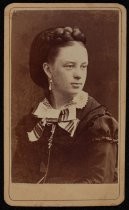 Portrait of woman with large braid and striped ribbon