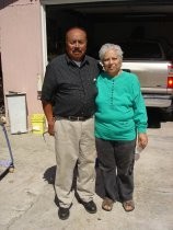 Elida and Ricardo Gutierrez in front of their home