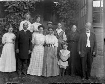 Group portrait outside building, boy in sailor suit, c. 1912