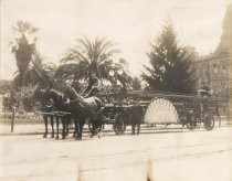 Horse-drawn fire engine and three firemen