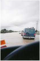 Cars on flooded street, possibly the 1998 El Nino Flood in California, c. 1998