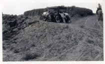 Pushing an automobile up a desert hill