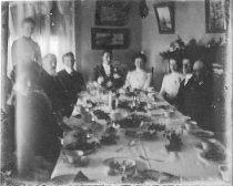 Group portrait around dining table, c. 1912