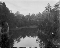 Water surrounded by trees, c. 1912