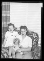 Portrait of mother and daughter with doll, c. 1940