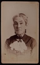 Portrait of woman with drop earrings and lace collar