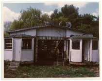 Men working on roof of trolley shed