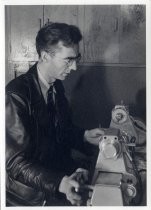 Portrait of Charles Litton at glass blowing machine