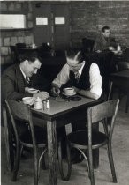 Two men in discussion in cafeteria, Motorola factory