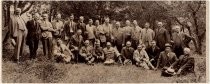 Group portrait of men in front of trees