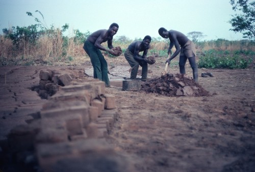 Men making mud bricks for a self-help community center in Kaputa village