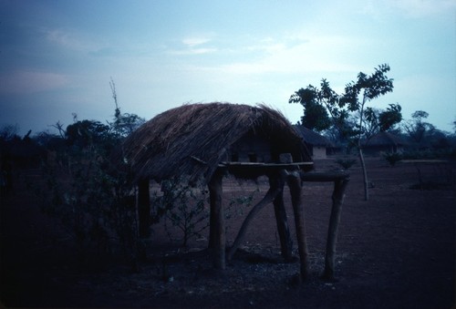 A chicken coop, next to a neighbor's home in Nsama village