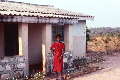 Mrs. Jane Mwango in front of her home, Nsama village