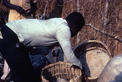 Mr. Rabbon Chola examines recently milled salt at a salt camp in Kaputa village