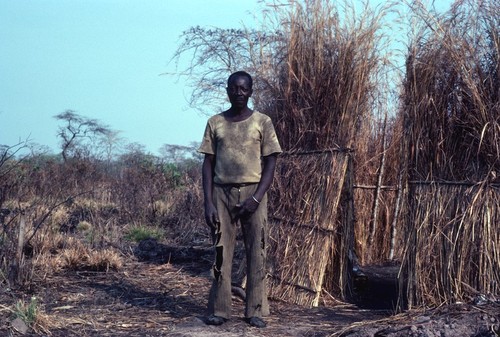 Man with garden, walled by thatched grass to keep out animals