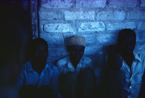 Men from Nsemiwe village, near Nsama, gather to tell stories and oral histories in the Swahili language