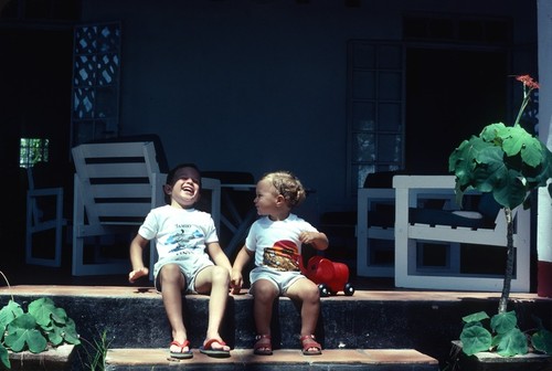 Portrait of Michael and Daniel Cancel on front porch of beach cottage at Diani Beach, Kenya