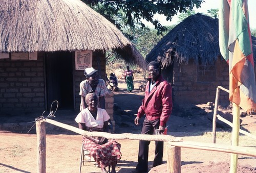 Portrait of Government Employees at the Gate at the southern entrance to Kasongole village