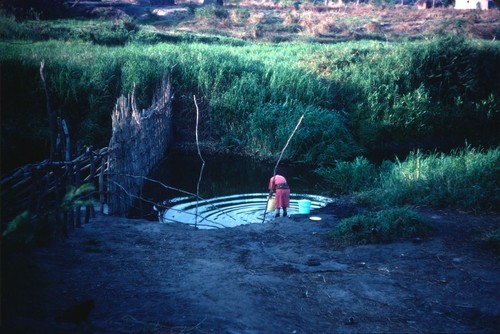 Ms. Donna Cancel drawing water from Choma River, Kaputa