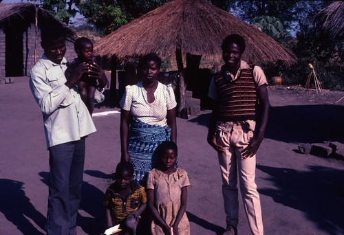 Mr. Rabbon Chola and his family in Front of their compound