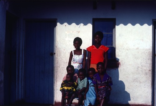 Portrait of neighbors in front of their home at Nsama village