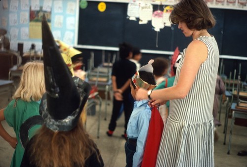 Teacher helps students prepare for a play at the International School of Lusaka, Zambia