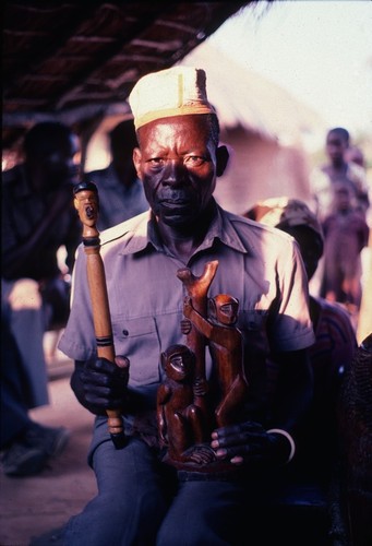 Sculptor holding items he'd made for the Kaputa royal lineage, Kaputa village