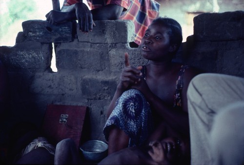 Storyteller inside nsaka (open gazebo) at Nsama village