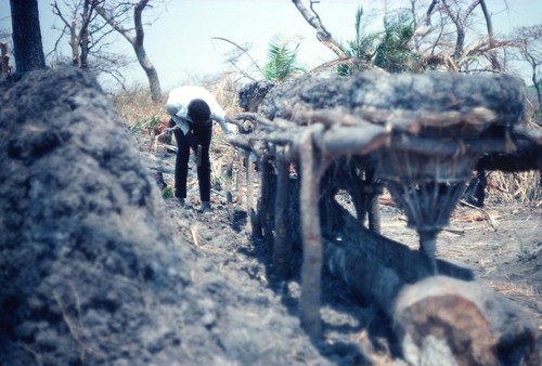 Mr. Rabbon Chola inspects a set of conical baskets made to leach brine from the dirt of the salt-making camp near Kaputa village