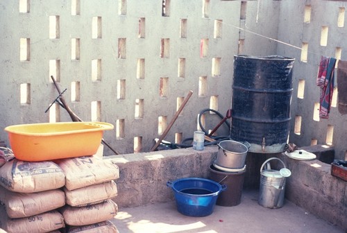 Household utensils and water barrel in home of Dutch medical workers at Kaputa village