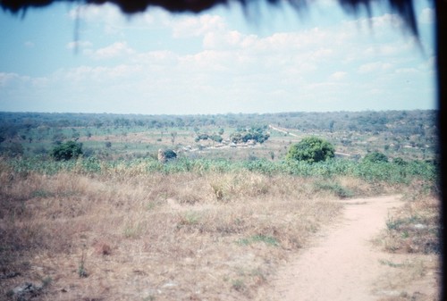 Paths intersect and view of distant landscape and road at Nsama, Northern Province, Zambia