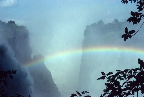 Mist rising from Victoria Falls, with rainbow