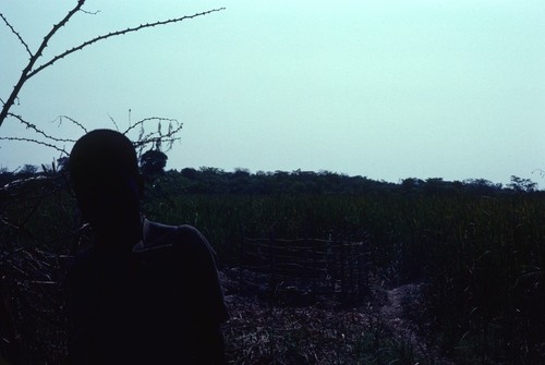 Man with fenced enclosure in background, Kaputa