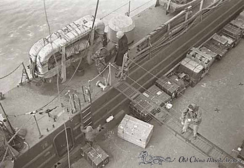 Repratriates exploring the desk of the ship LSM (Landing Ship Medium), Tientsin, 1946