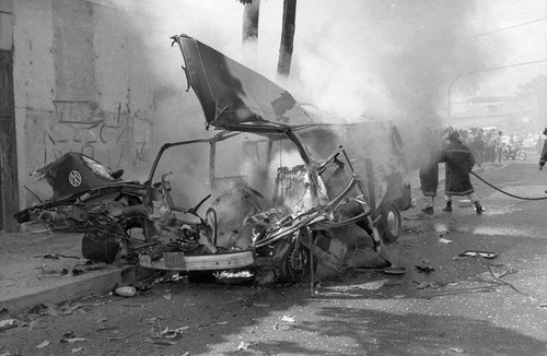 Vehicle burning in the street, San Salvador, circa 1980