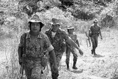 Four soldiers patrolling mountainous terrain, Guatemala, 1982