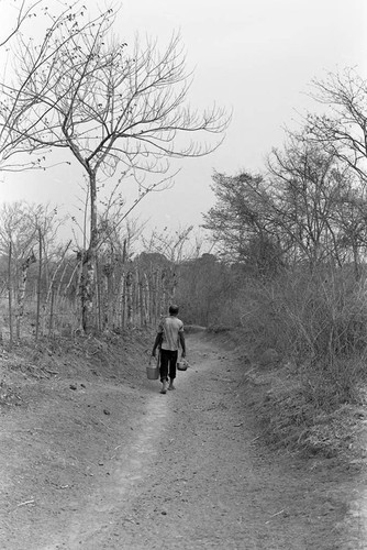 Man carrying a bucket, San Basilio de Palenque, 1977