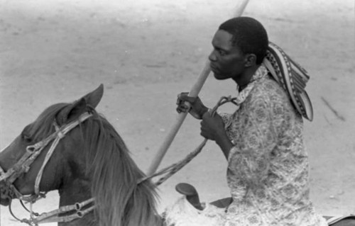 A picador on a horse holds a lance in his hand inside the bullfight arena, San Basilio de Palenque, 1975