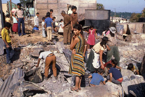 Civilians search through the rubble, La Palma, Chalatenango, 1983