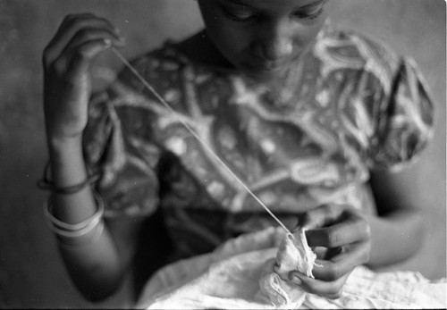 Girl sewing a garment, San Basilio de Palenque, 1977