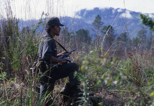 Young Contra soldier observes the countryside, Nicaragua, 1983