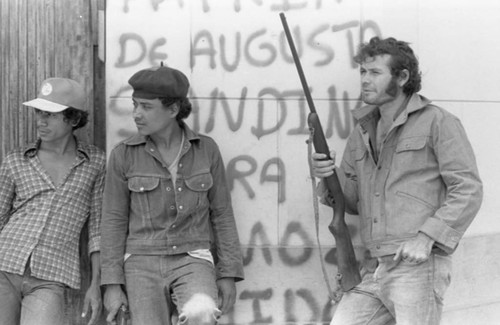 Sandinistas in front of graffiti, Nicaragua, 1979