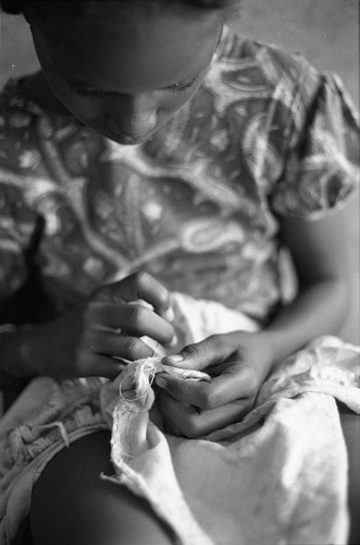 Girl sewing a garment, San Basilio de Palenque, 1977