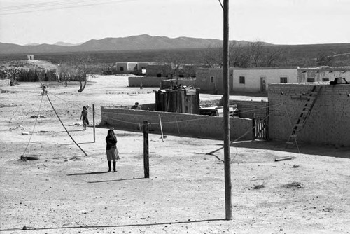 Woman and a group of children near train tracks, Chihuahua, 1983