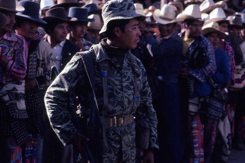 A soldier and a line of men to vote, Nahualá, 1982