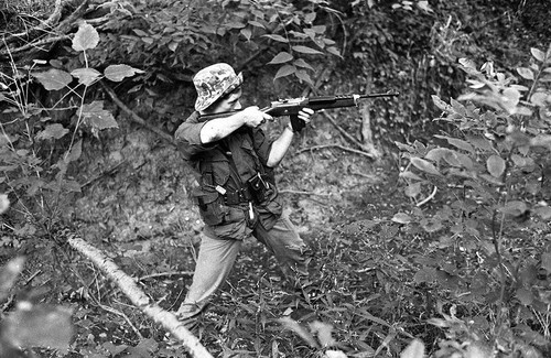 Survival school student holds a rifle, Liberal, 1982